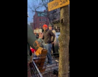 People serving gumbo from window 