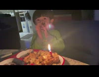 Boy sings happy birthday on a smashed cake