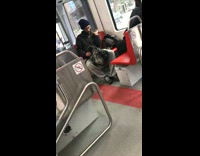 man with long beard dances sitting down train