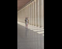 White shirt guy catwalks spins columns backpack 