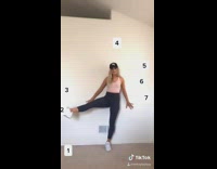 Flexible girl lifts leg to each number 