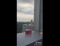Two guys playing beer pong at penthouse