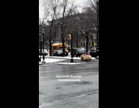 Mini car driving in New York sidewalk on rainy day