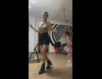 Woman dances while kid swings on rope 