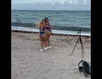 2 ladies in matching swimsuits do dance for video 