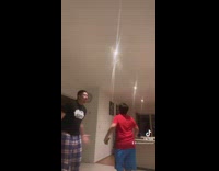 Two guys spinning with vegetables in kitchen 