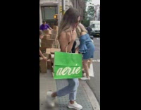 People help man stack fallen boxes 