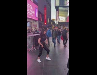 Girl black pants dance on times square