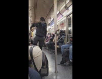 Hip hop dancer performs in train aisle 