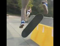 Guy on skateboard jumps over traffic barrier 