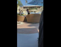 Woman one shoulder top selfie brown chairs