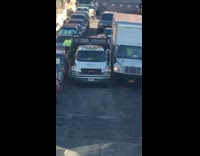 Two pick up trucks get jammed and stuck in narrow street