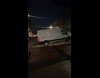 White van stuck on the street divider