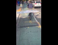 Man rides bike with box at back
