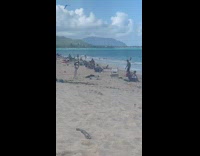 Guy black shorts struggle with handstand beach