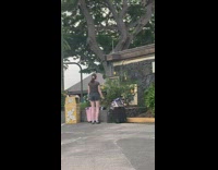 Woman tiktok dance near her luggage at the park