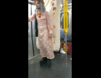 Guy wears bug mattress with dress on train 