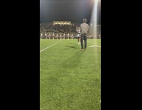Cheer leader band guy throws stick back