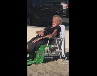 Woman on white beach chair fell asleep on green blanket