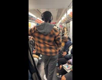 Man vocalizing inside subway train