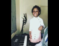 Dad plays piano while little girl sings along