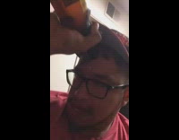 guy spilling drink on himself and holding toward forehead 