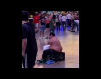 Street performer with no arms plays drums 