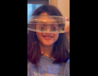 Girl eyes look weird through water bottle