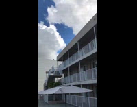 Boy do tricks jumps rooftop to pool