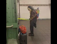 Guy uses yellow resistance band subway station 