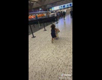 Little girl rides suitcase and falls in airport 