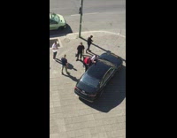 Guy white shirt sit above black car