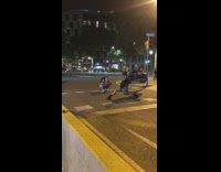 Woman in black outfit weird half split on the street