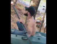 Guy sits blue kayak boat mountain ground