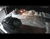 Man plows driveway snow falls from tractor