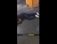 Guy and girl passed out in parking lot bottle of alcohol