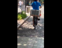 Guy rides back with aircon at back