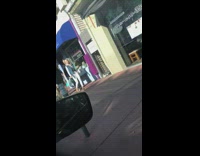 Group walks down sidewalk for video 