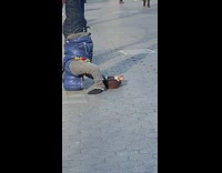 man blue puffy jacket handstand in street