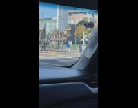 Woman in violet top poses at the railway