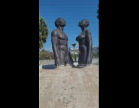 Sculpture of naked man and woman stare up 