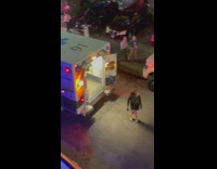 Woman black dress pose behind ambulance night