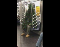 Guy wearing christmas tree rides subway alone 