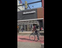 Guy sings while riding white bicycle street
