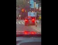 Black car tries to fit in sidewalk
