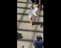 Collab Subway Creatures - Barefoot woman white dress dances randomly at train station