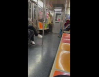 man stares at himself and freshens up in subway car window