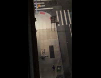  Man with box on head laying on sidewalk