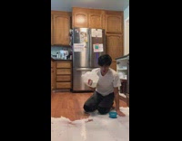 Guy stands in cups, makes breakfast for kids, falls and breaks gallon of milk open