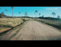 Drone flies through dirt road spins flips